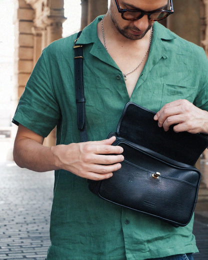 Black leather crossbosy bag with clasp and zip.
